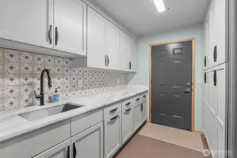 The massive pantry with a walk-in featuring custom shelving and a shower