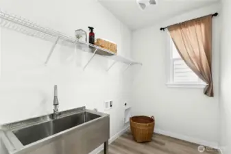Separate laundry room with large sink just off the entry.