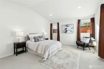 This over-sized primary bedroom has lots of room for a seating area, dressers, and a king-size bed!