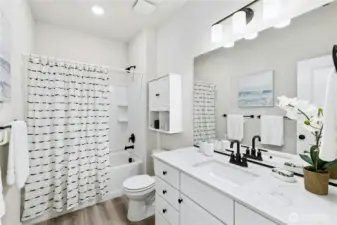 The guest bath has quartz counters and a full tub/shower combo.