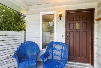 Welcoming front porch with room for seating and views of the property.