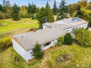 Aerial view highlighting the home’s generous lot and scenic backdrop.