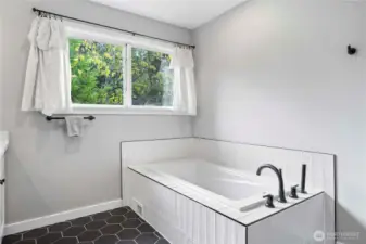 large bathtub in primary ensuite