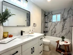 Elegant Full Bathroom w/ceramic tiles, blending style and durability.