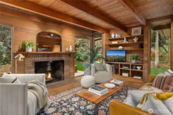 The wood-burning fireplace is center stage with beautiful built-in cabinetry.