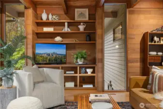 Thoughtful built-ins flanked by windows in the living room.