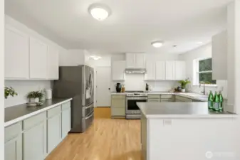 Updated kitchen with custom-painted cabinetry and modern finishes.