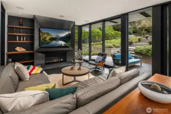 Basalt tile floors that flow to the patio and a blackened steel fireplace mirrors the fireplace in the original living room
