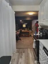 Kitchen into the living room. Large pantry space on the left.