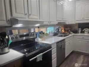 Kitchen space with new granite countertops.