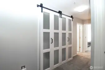 Laundry, with door closed, in hallway