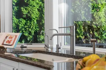 This attention to detail allows you to enjoy the serene outdoors while performing daily tasks, making kitchen chores more pleasant. The window’s placement not only provides a picturesque backdrop but also floods the space with natural light, enhancing both the aesthetics and ambiance of the kitchen.