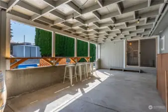 Large Covered patio looking towards dining room and pool area