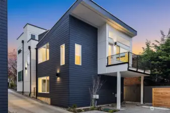 Elegant standalone homes bathed in the warm glow of dusk offer modern living in Capitol Hill's vibrant heart.