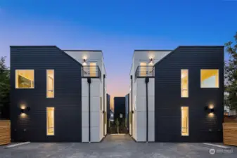 Stylish symmetry and bold lines define these twin residences, set against a breathtaking sunset backdrop.