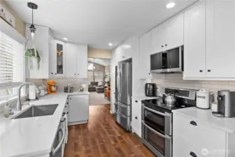 Beautifully updated kitchen featuring modern cabinetry, sleek countertops, stainless steel appliances, and under-cabinet lighting for a stylish, functional finish