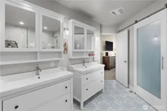 Stunningly updated primary bath complemented by a one-of-a-kind walk-in closet.