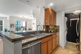 From the heart of the kitchen, enjoy open-concept living with stunning views of the dining area, office nook, and a majestic cruise ship docked beyond.