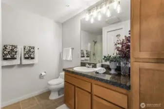 Bathroom #2 shines with refreshed vanity lighting, adding a modern touch to this spacious stylish 3/4 bath.