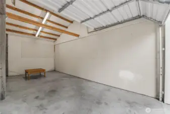 Owner has divided the garage into 3 bays. You should be able to remove the sheetrock and open it up to 1 big shop.