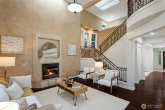 Architectural interest throughout with graceful curved lines, two story great room and statement wrought iron staircase with custom detailing