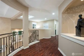 The architectural details in this house is stunning! Upstairs hallway overlooking the great room below.