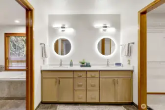 Lighted vanity with walk in closet to the R and bathrooom to the L.