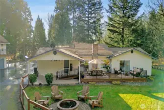 Deck and fenced back yard. Outdoor furniture virtually staged.