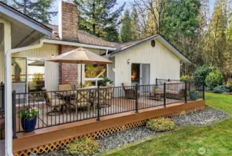 Deck with easy access from living and primary bedroom. Outdoor furniture virtually staged.