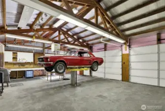 Shop with car lift, compressor, and air lines for your auto needs. Car virtually staged over car lift.