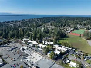Aerial looking NW. Hillwood Park and Albert Einstein Middle School are in the upper right. QFC, Starbucks, Swedish Primary Care, Santa Fe Mexican, Wells Fargo bank, and other shops are in the complex on the lower left of the photo.