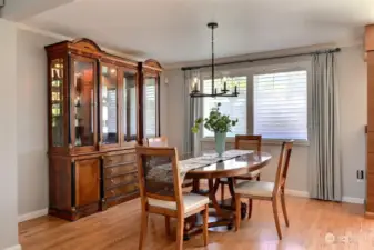 Open to the living room and kitchen, this dining room offers a view of the peaceful backyard.  The custom window coverings enhance the home's elegance while providing privacy and light control.