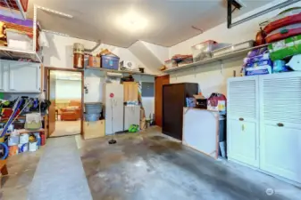 Oversized Double Car Garage with Lots of Wall & Overhead Storage & Additional Shop Space.