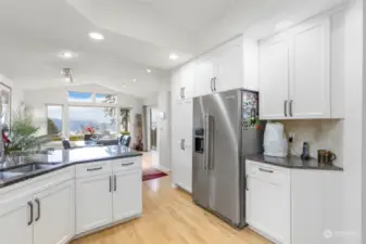 The newly remodeled kitchen with ample hosting dining area with access to back deck for gatherings or private evenings watching your personal oasis.