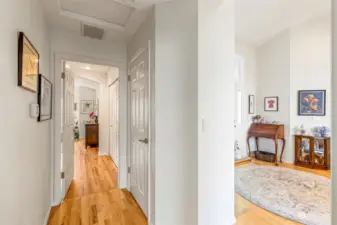 A view from the primary bedroom to the 2 bedroom or guest bedroom. Please note the hall closet to the left.