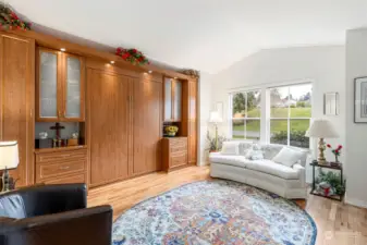 This home allows the use of this room as another sitting room or crafting room. A custom built in Murphy bed allows space saved then used for guests if needed. The view here is the common are across the street which has summertime community wine tastings.