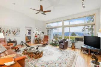 The great room allows for multiple art features along wiith large furniture. The astounding views are just outside those wall to ceiling windows.