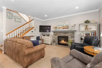 Family room with cozy fireplace and crown molding.