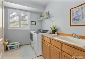 Conveniently located upstairs laundry room with utility sink and tons of storage space!