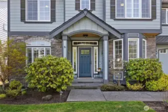 Welcoming covered front porch with cedar wood soffit and upgraded Andersen door.