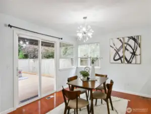 Elegant dining nook with pendant lighting and an open view of the backyard