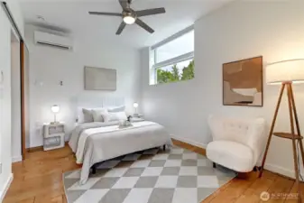 Beautiful upstairs primary suite featuring soaring ceilings, a mini-split A/C system and a private deck.