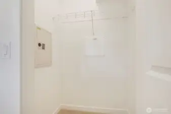 Walk-in closet with electronic wall safe.