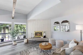 Spacious open floor plan with ceiling to floor windows.