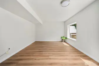 Basement living space with new laminate vinyl plank flooring