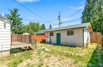 Stairs from the deck lead to the large backyard and detached garage.