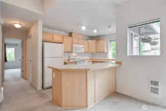 Open kitchen with eating bar.