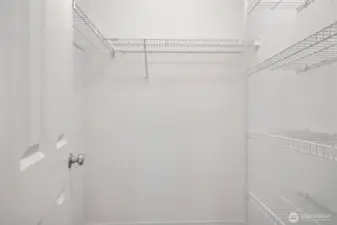 Walk in closet with custom shelves.