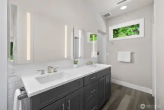 Primary en suite. The water closet is to the left of the vanity. The walk in shower is on the right of the vanity.