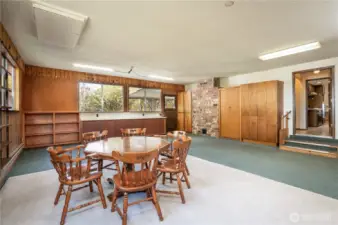 Huge great room with lots of built-ins and shelves offering loads of storage. Doorway on the right leads to the utility room/ kitchen. Backdoor takes you to the covered patio & backyard.